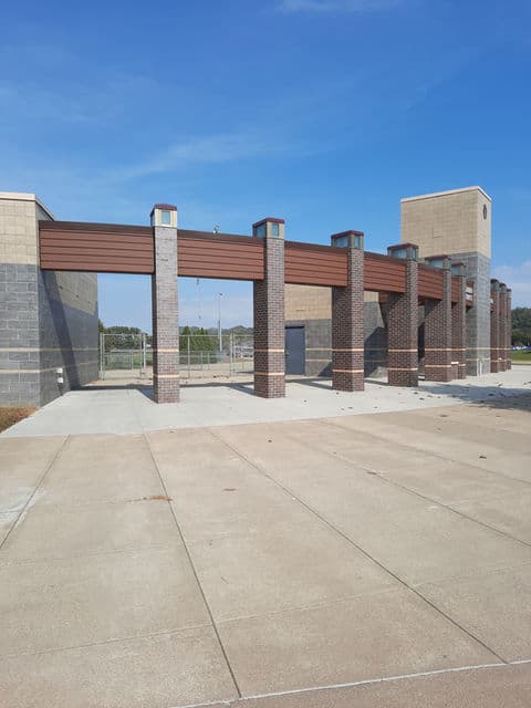 Detail of installed metal wall panel with vertical reveal